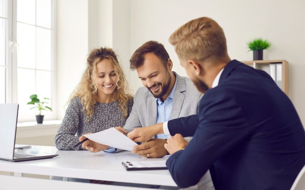 Couple Meeting with an Experienced Realtor to Write an Offer on a Home