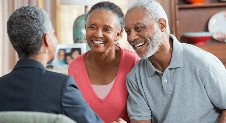 A couple talking with a Realtor about selling and buying a home